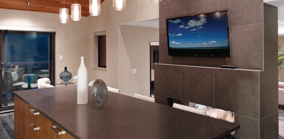 Contemporary kitchen with island and wall mounted tv