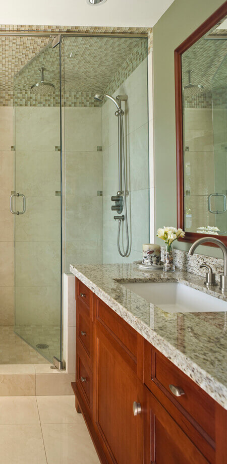 Traditional cabinetry and rich quartz countertops finish this bathroom in North Vancouver home reno