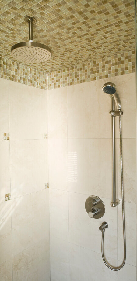 detail of mosaic tile and rain head in shower of north vancouver renovated home