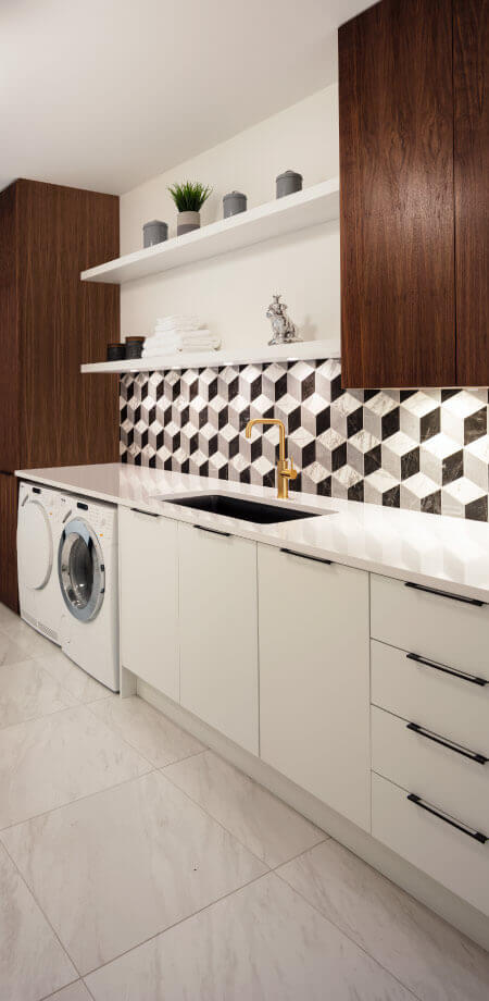 Laundry Room with Art Deco Backsplash Tile by TQ Construction