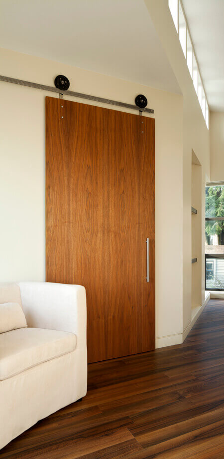 stylish solid wood barn door featured in master suite north Vancouver addition