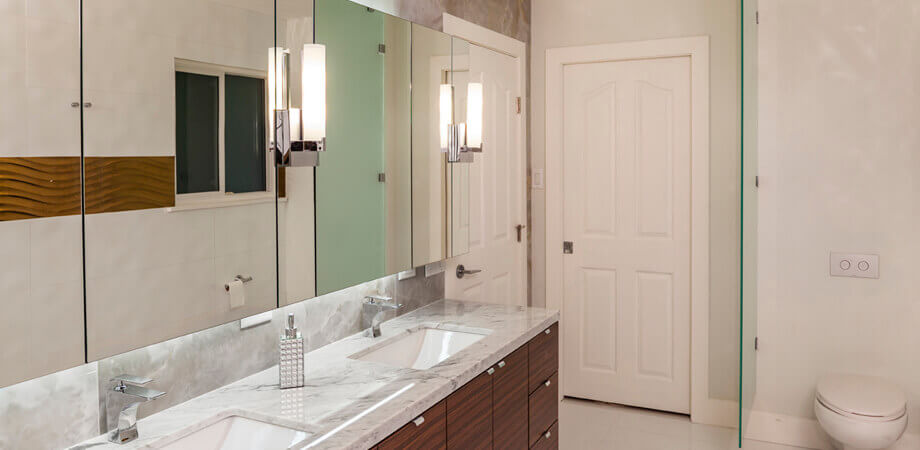 The details prevail in this high end bathroom renovation with toilet privacy behind glass partition