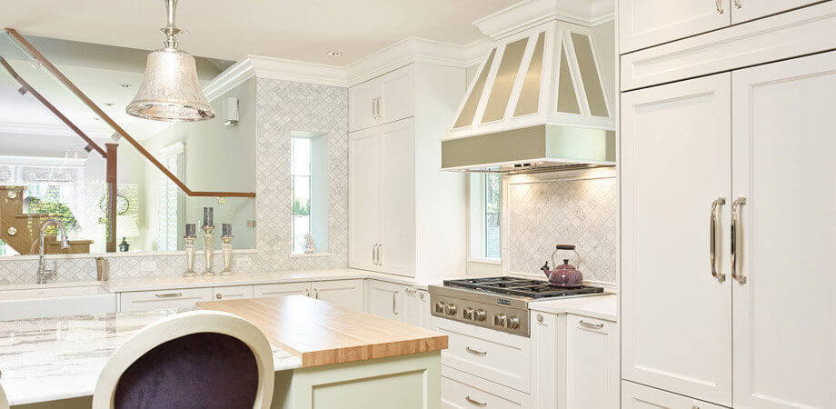 French Country Kitchen with Range Hood and Stone Slab Island
