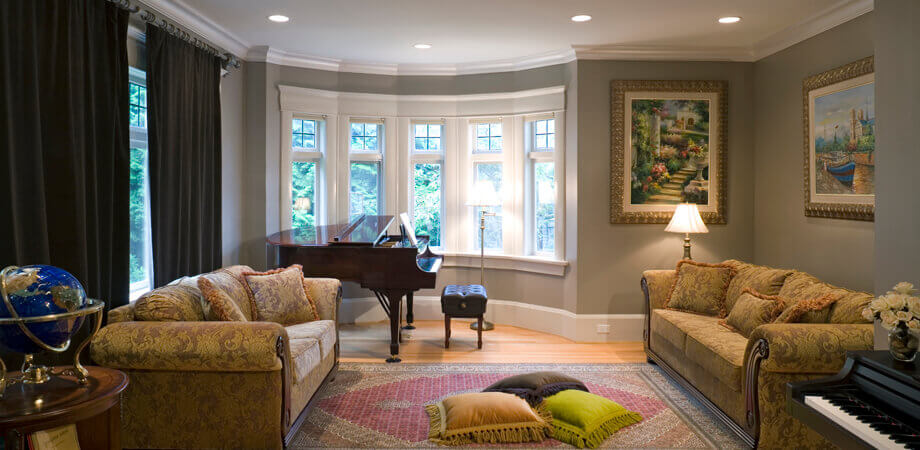 living room with formal furnishings and piano in bay window alcove heritage home renovation