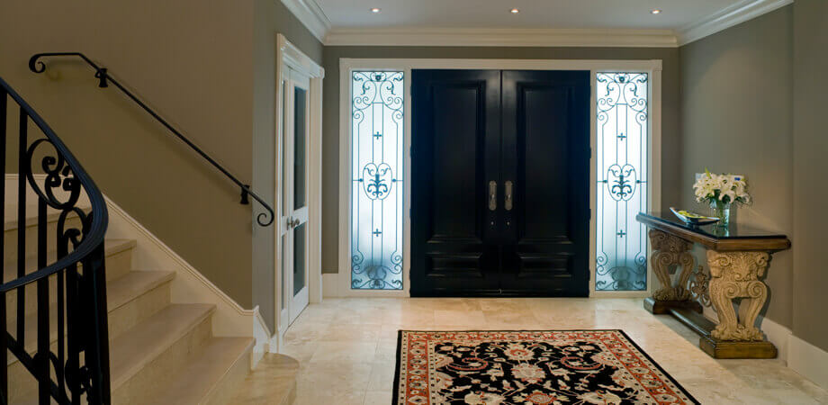 travertine and iron featured in elegant entryway vancouver traditional style home renovation