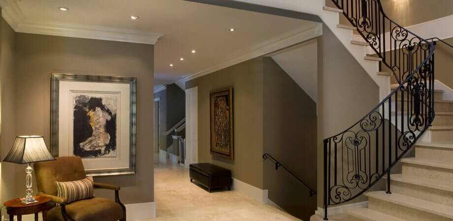 formal vancouver home entrance with travertine tile and wrought iron railings